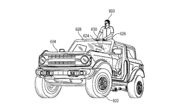 Ford's Bronco convertible SUV is piloted by a driver while standing in the footwell of the vehicle and using buttons mounted on the windscreen frame to control it.