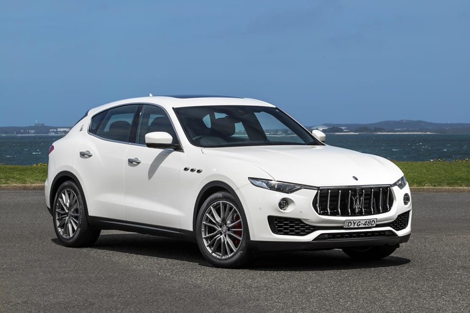 The Maserati's long bonnet is flanked by curvaceous wheel arches with their vents, leading towards a grille that looks ready to eat up slower cars.