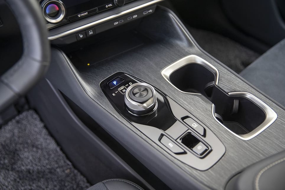 Upfront is a dial shift knob in place of a gear lever.