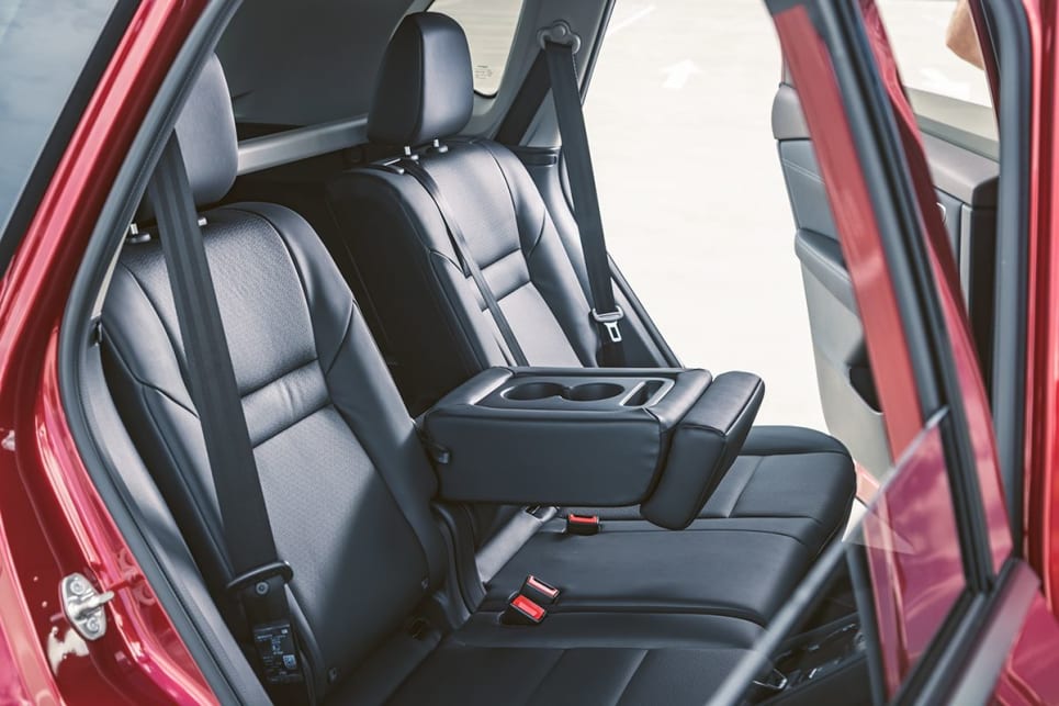 Rear passengers will find decent bottle storage in the doors and a fold-down armrest. (ST-L variant pictured)