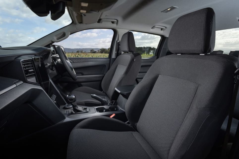 The steering wheel feels low end, the flooring is vinyl, and there's a manual parking brake, cloth seats and hard cabin materials. (Core variant pictured)