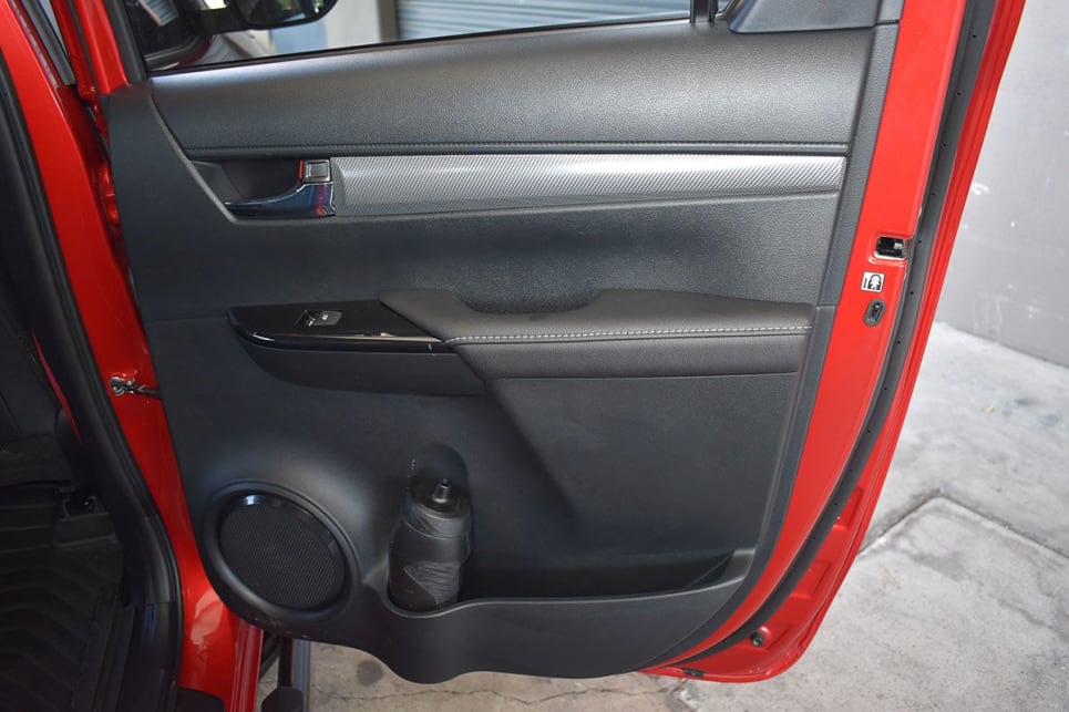 Rear passengers get a bottle holder and bin in each door, pockets on each front seat backrest and a fold-down centre armrest with two more cupholders. (image: Mark Oastler)