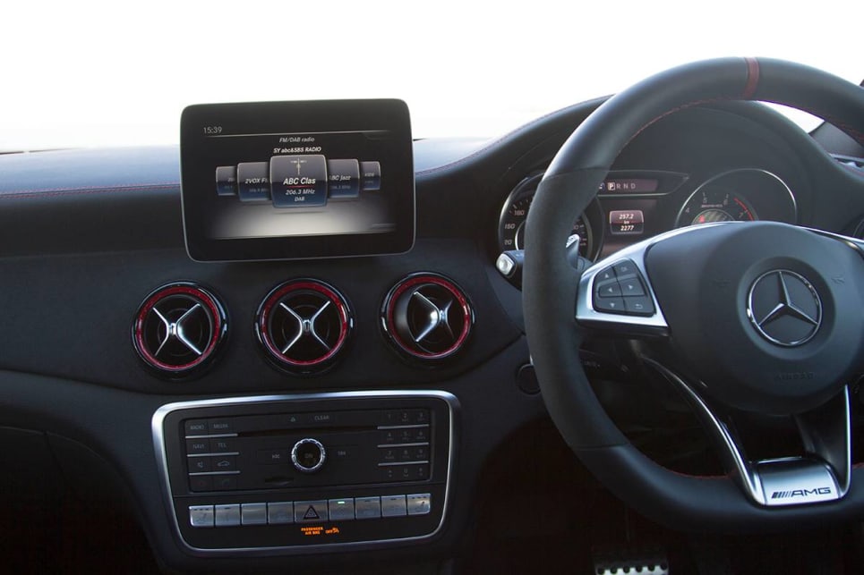 The ergonomic disaster of a column-mounted shifter in the GLA is removed, with a console-mounted shifter added where a small cubby once lived. (image: Peter Anderson)
