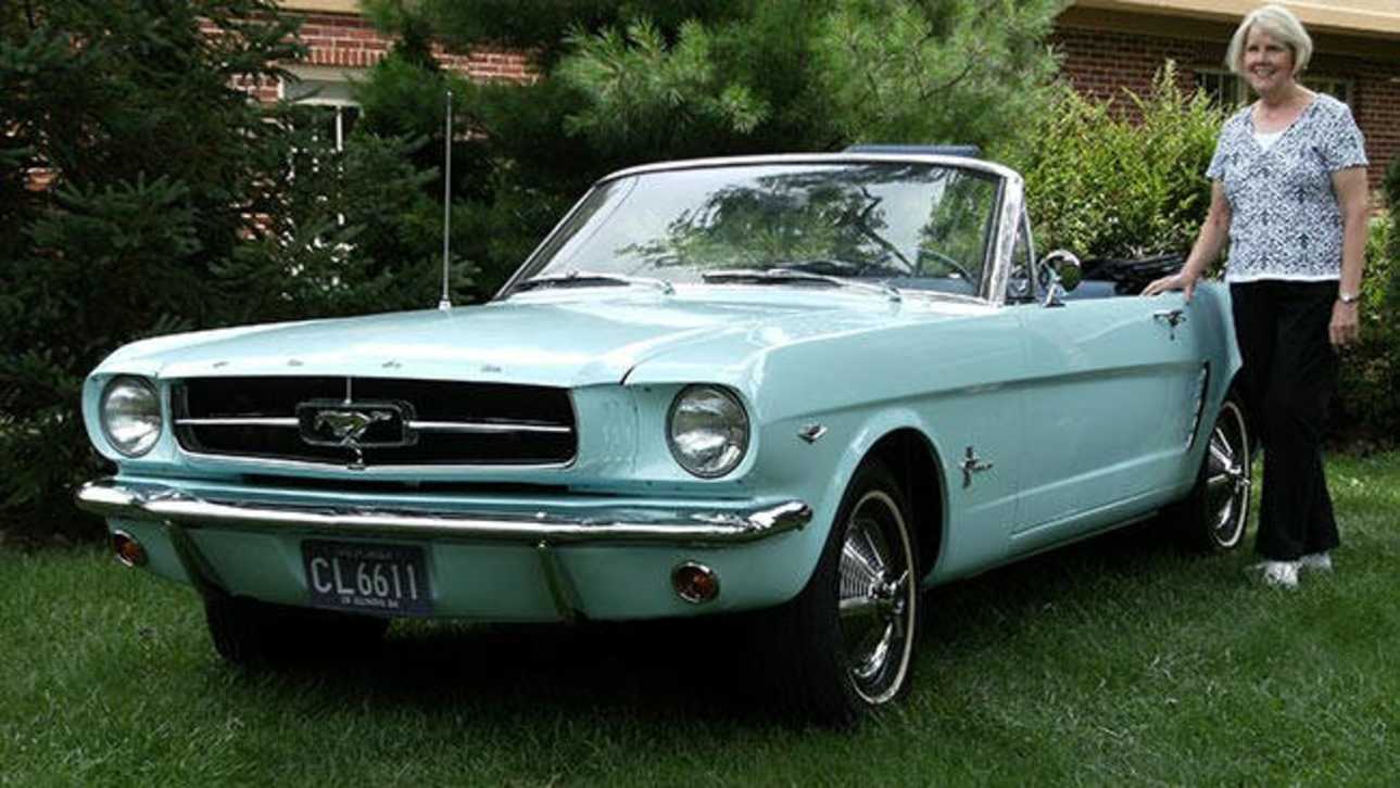 Gail Wise with her restored 1964 Ford Mustang convertible.