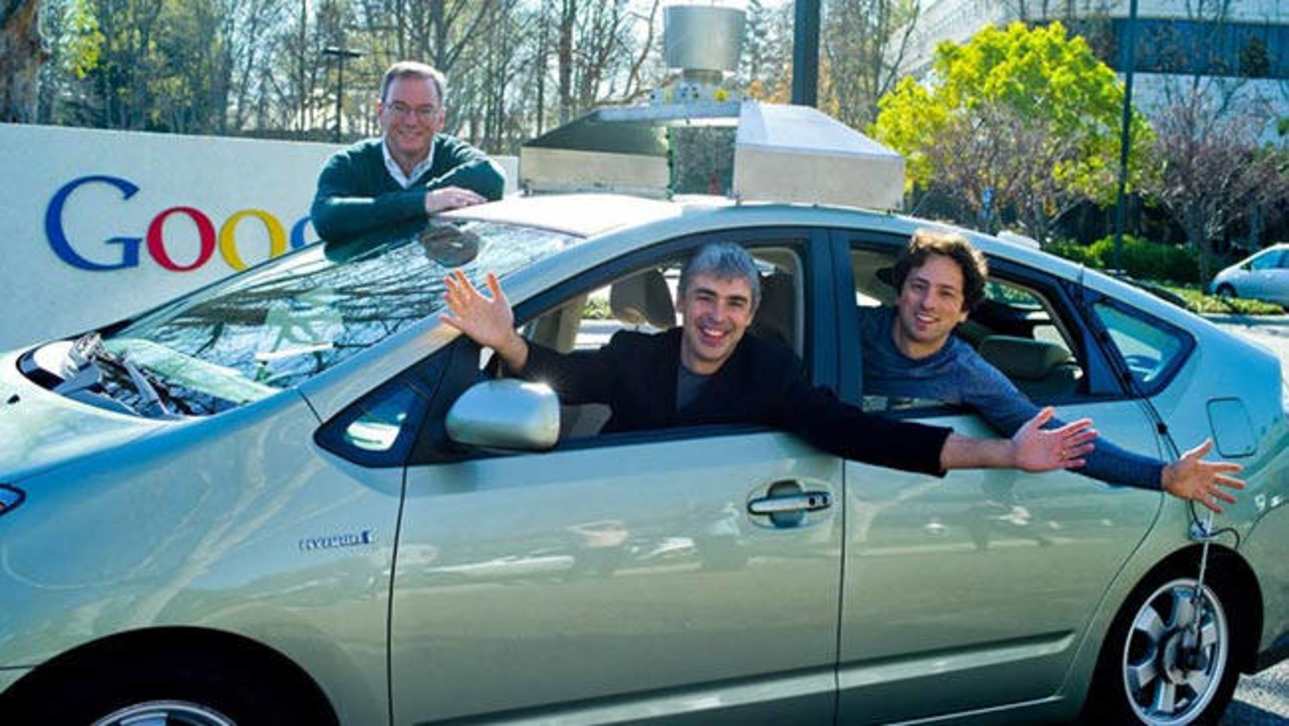 The founders of Google and one of their autonomous Toyota Prius hybrids.