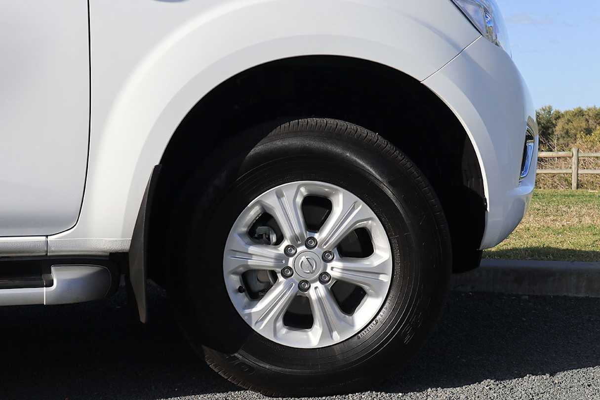 The standard 16-inch alloy rims are shod with more highway-oriented all-terrain tyres, detracting from the Navara's macho visage. (image credit: Tim Robson)