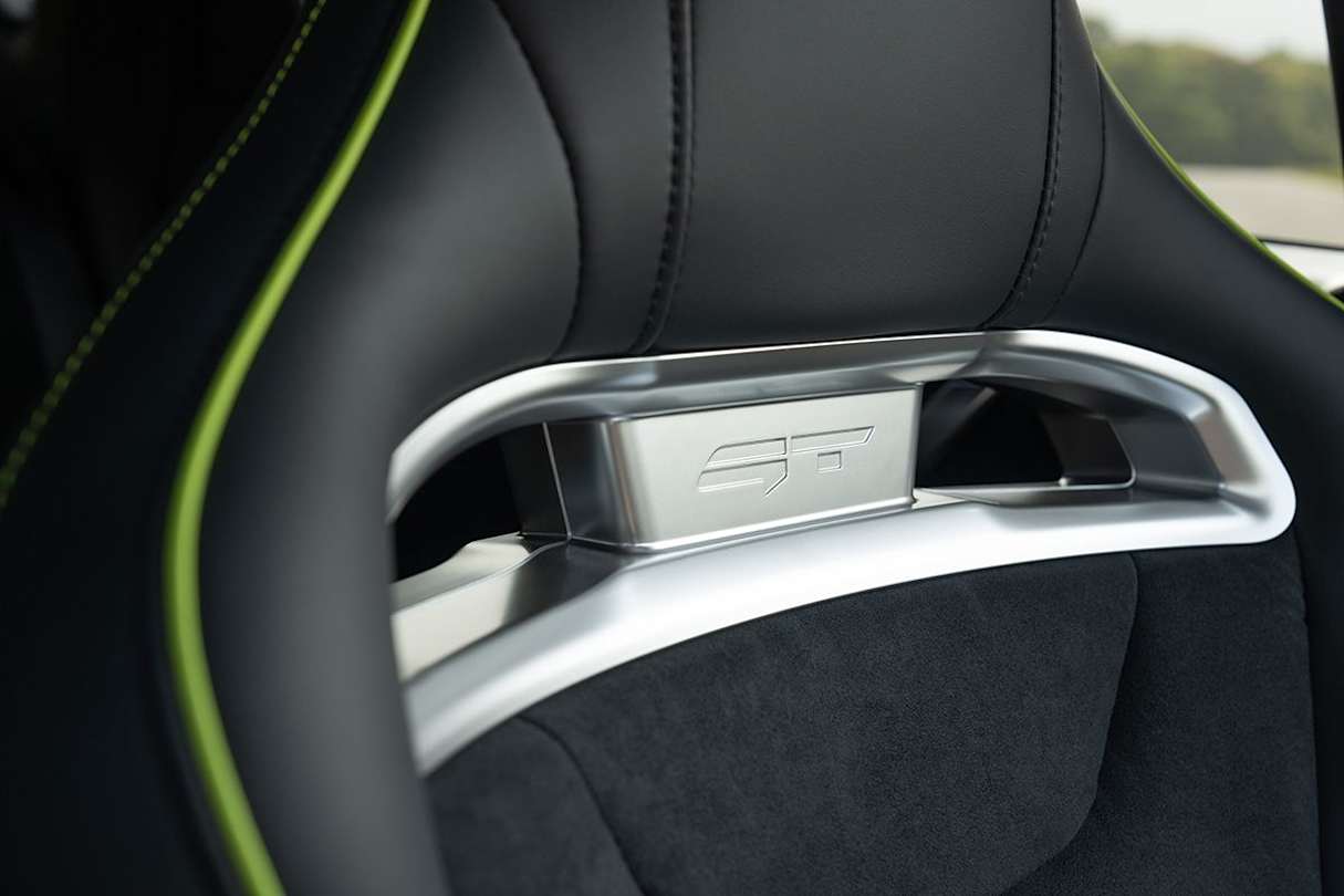 The manual seats have been put in place of power front seats to save weight and free up headroom.