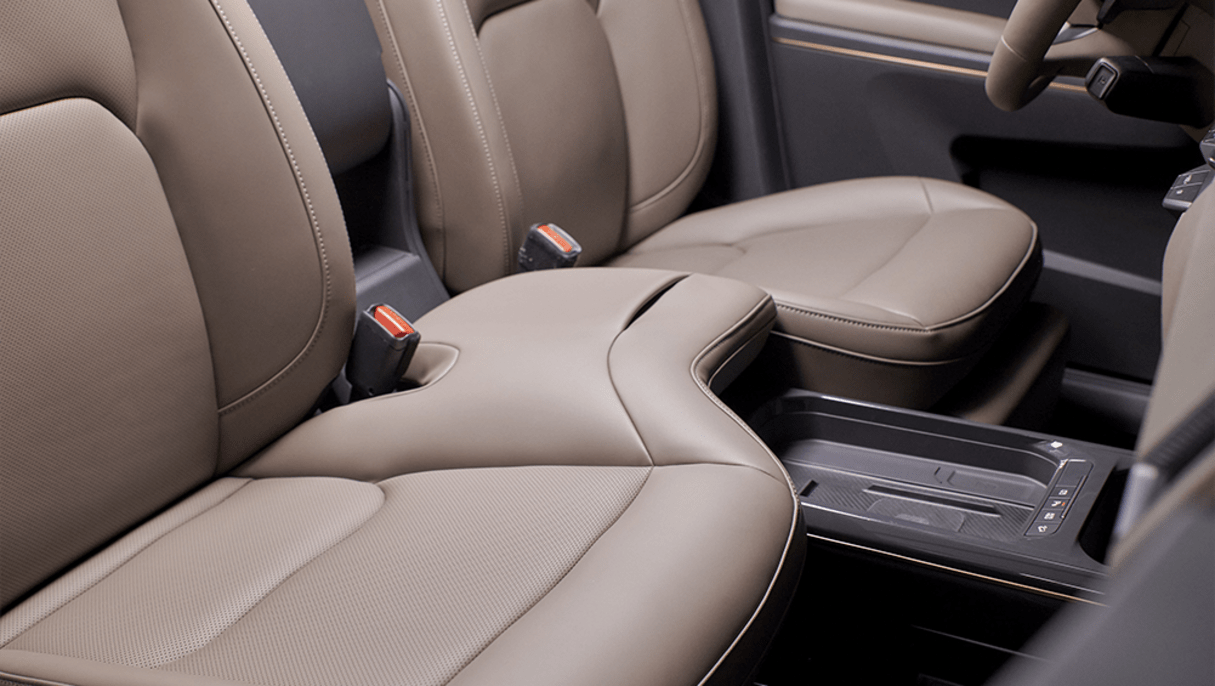 The front passenger seat extends over to the (separate) driver’s seat.