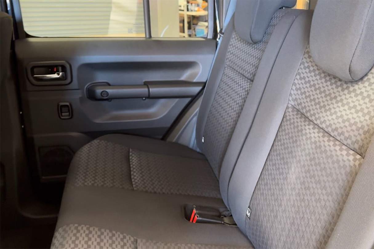 The Jimny XL solves this problem with a longer wheelbase which allows for rear doors that give great access to a second row which has plenty of head- and legroom for even me at 189cm tall to sit behind my driving position. (Image: Richard Berry)