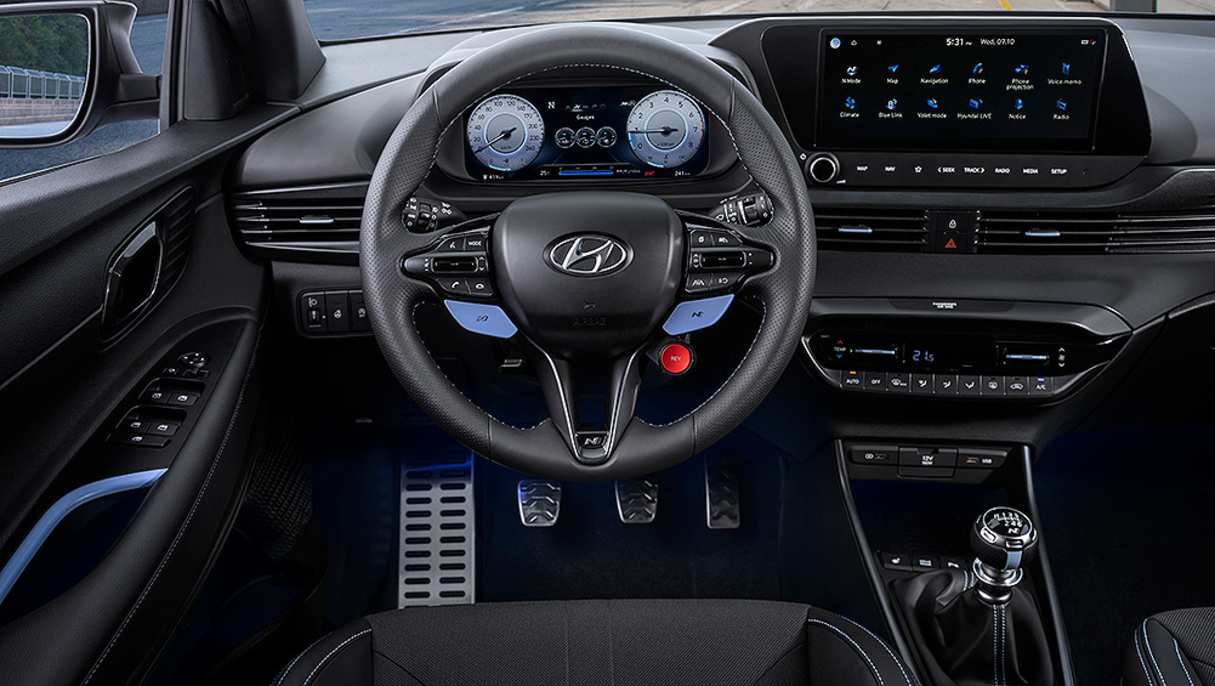 A large 10.25-inch multimedia display features special software to monitor the driver's track performance.