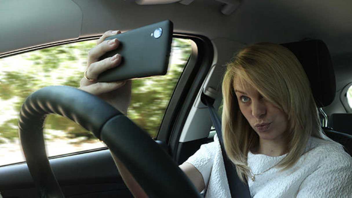 Even at a red light, you can&#039;t touch your phone unless it is in a cradle.