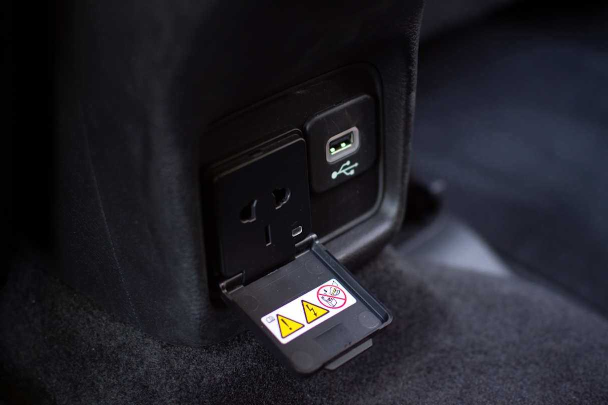 Back seat passengers score a super-practical standard 240v outlet and a USB port. (image credit: Tom White)