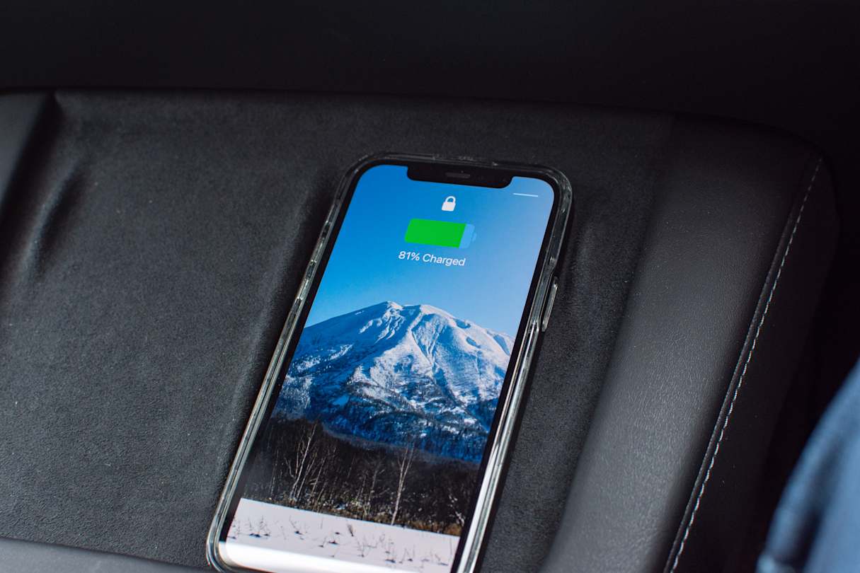 A very welcome dual wireless phone charging pad appears under the screen.