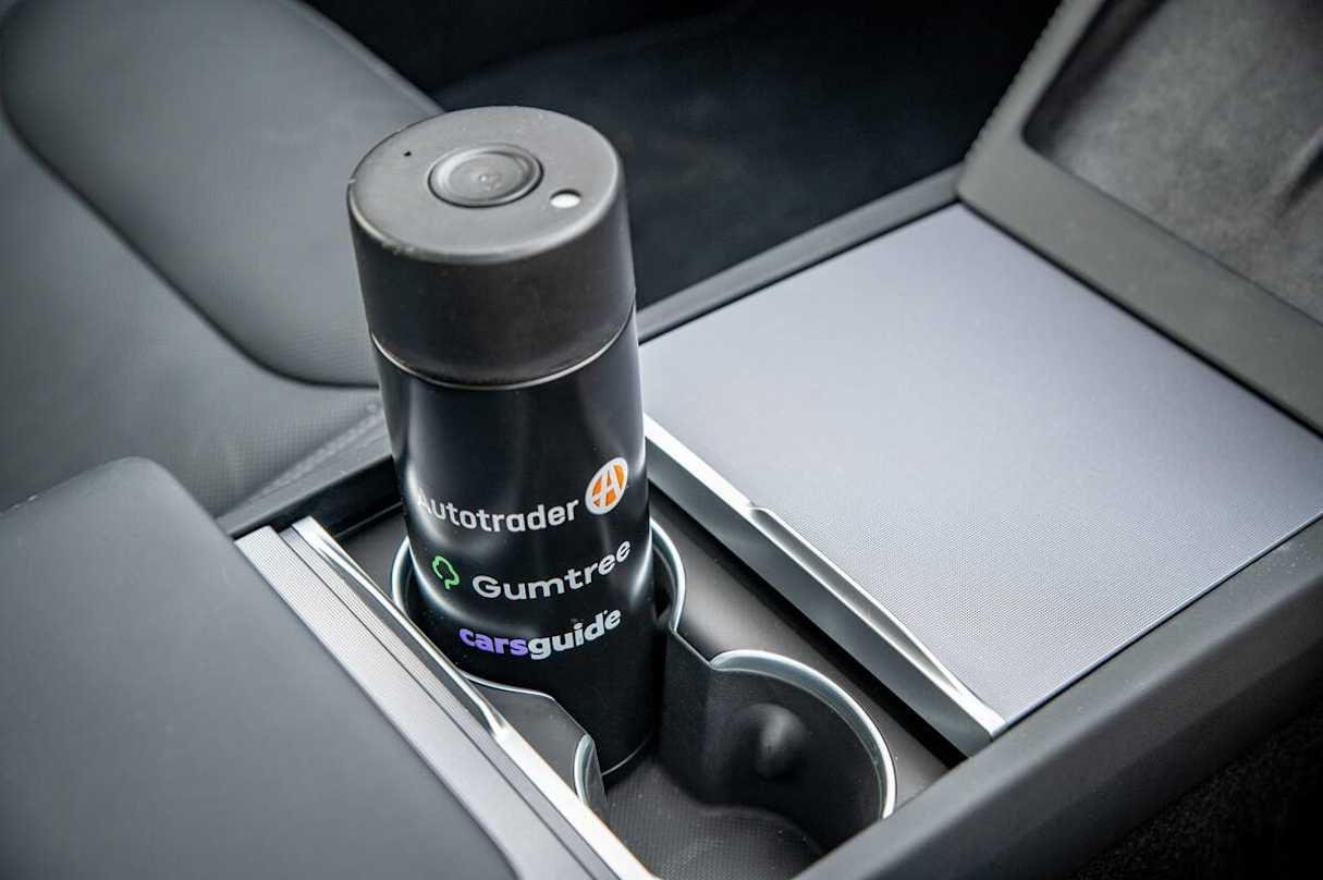 There is a set of large bottle holders in each door with two more under a slide-open cover in the central console. (image: Tom White)