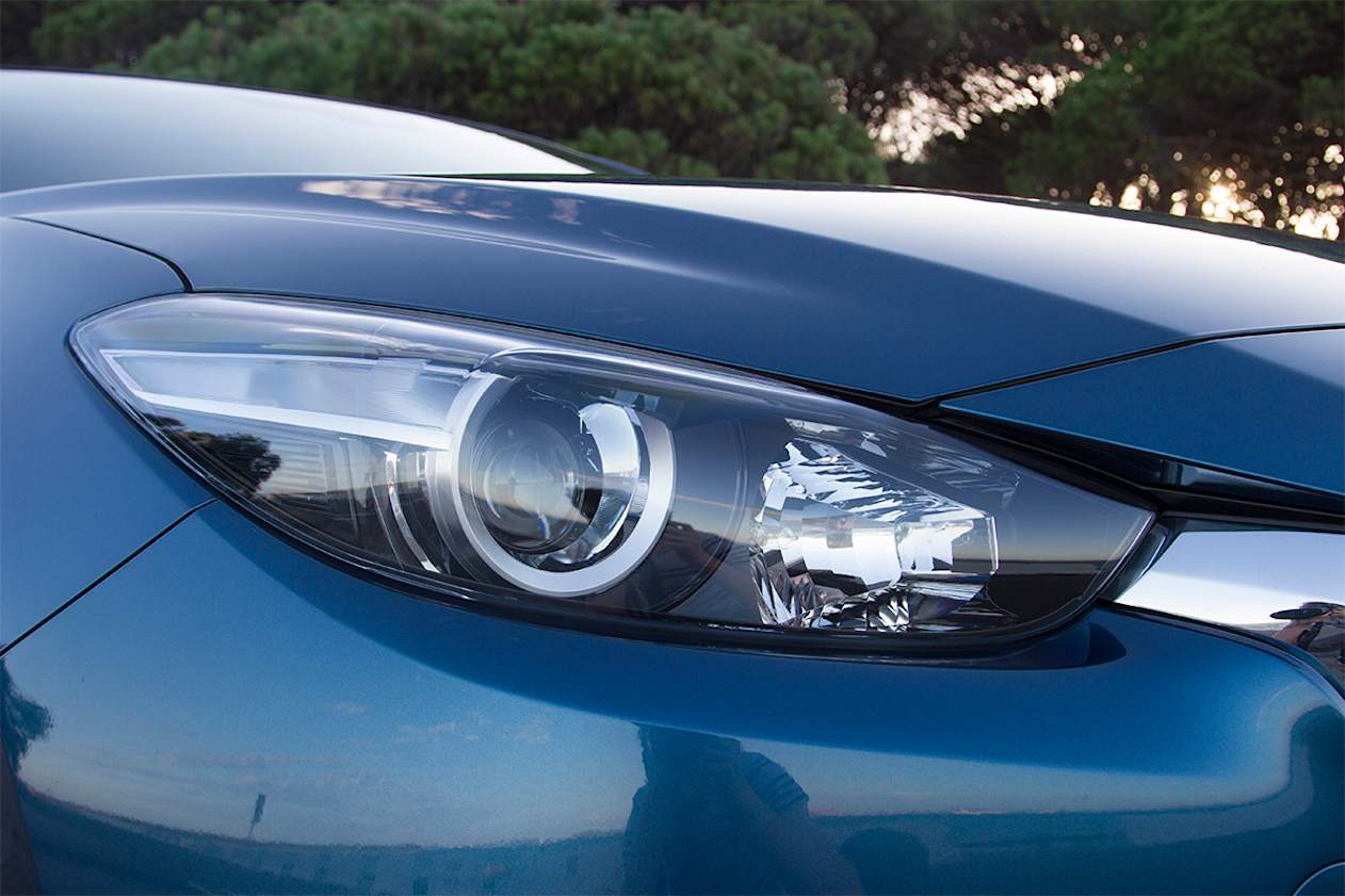 The Mazda 3 comes with projector-style halogen headlights. (2018 Touring model shown)