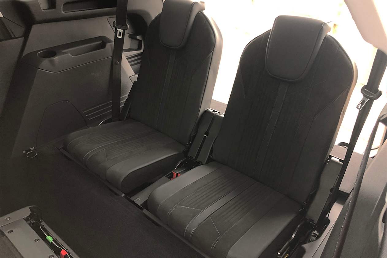 The third row has small cupholders moulded into the sides.