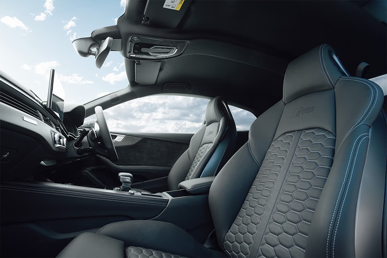 The two spacious seats are separated by a sizeable centre console. (Coupe variant pictured)