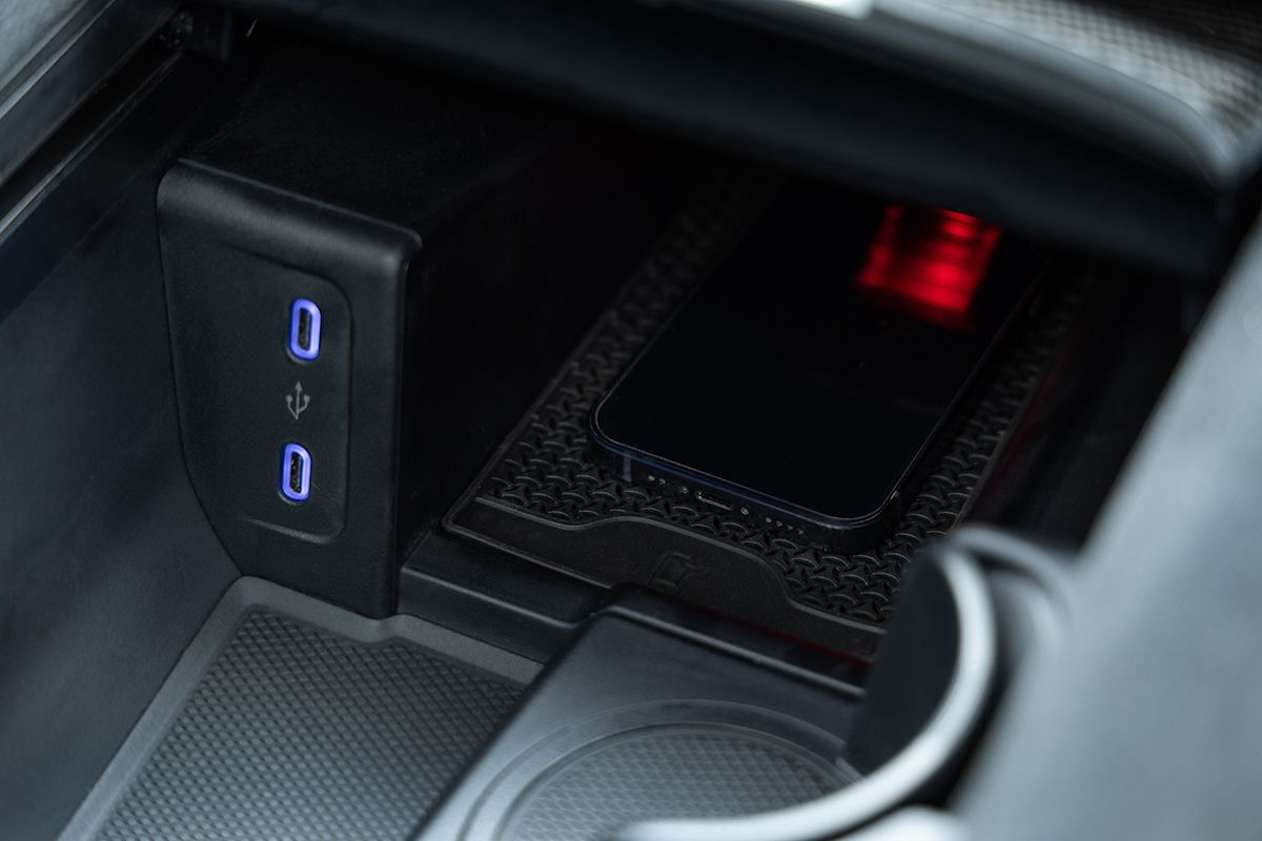 The EQE features a wireless smartphone charging pad. 