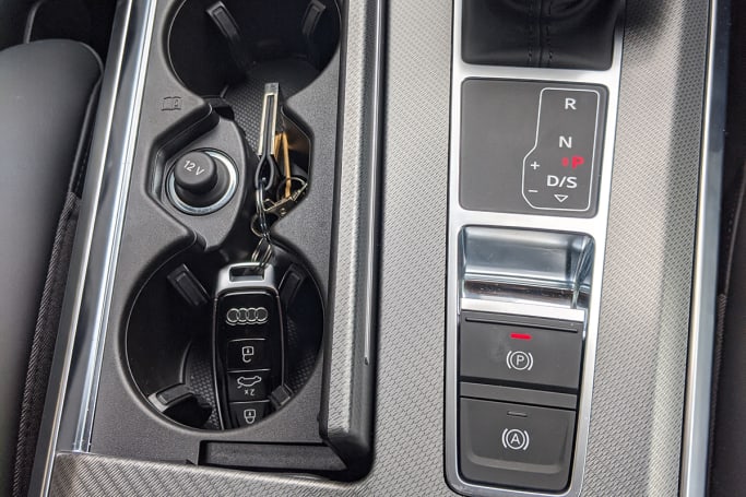 There are two cup holders adjacent to the gear shifter.