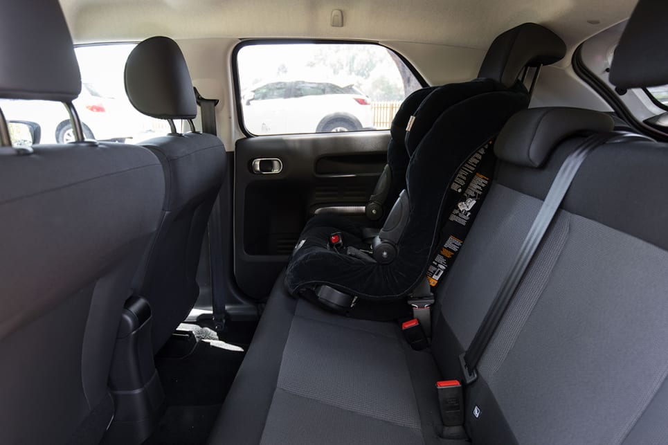 There is a good amount of room in the back, and it fits carseats perfectly fine.