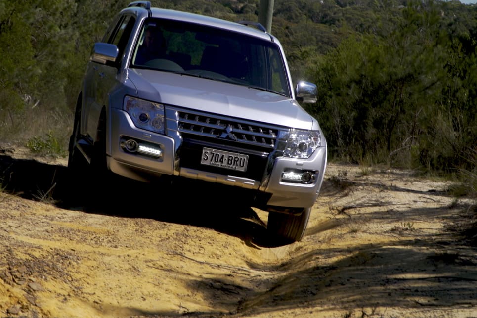 Drive in the ruts if you think you have enough ground clearance; straddle the ruts if you don’t.