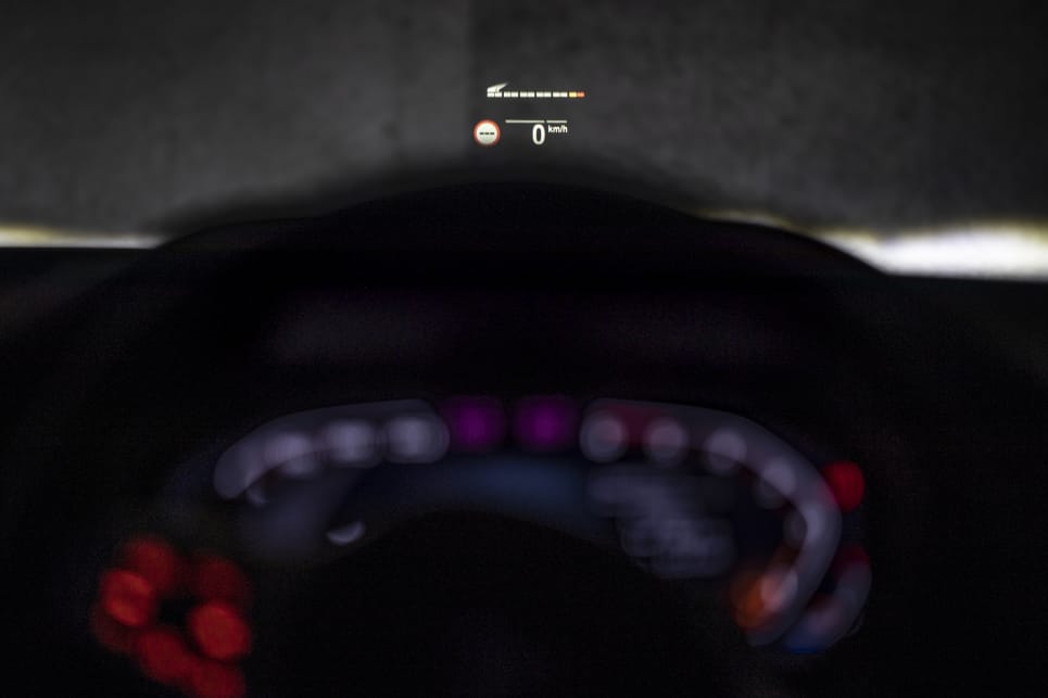 The head-up display shows speed, engine data, road information, and navigation instructions.