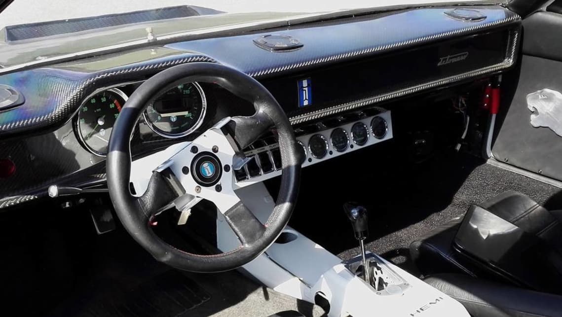 The cabin features a full carbon fibre dash and obscure Italian gauges that don't really work. (image credit: Hotrod.com)