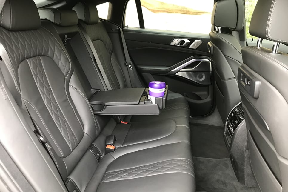 Back seaters are provided with a fold-down centre armrest incorporating a flip-top oddments tray and a pair of pop-out cupholders. (image: James Cleary)
