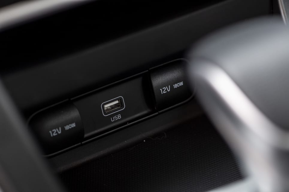 There is a large, front-console area with two USB ports and a 12V outlet.  

