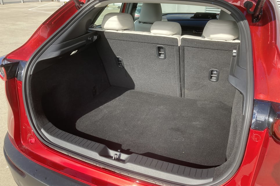 Happily, the CX-30’s boot area beats the meagre 3’s 295-litre capacity, by just 22L to 317L. (image: Byron Mathioudakis)