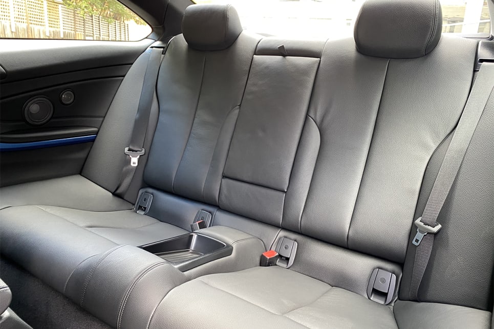 Rear occupants can make use of a large storage tray that resides where a middle seat would otherwise go.