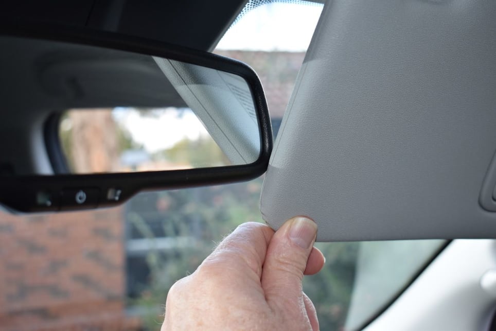 When you swing down the visor and push it towards the windscreen, the padded edge of the visor clips the edge of the rear-view mirror. (image: Mark Oastler)