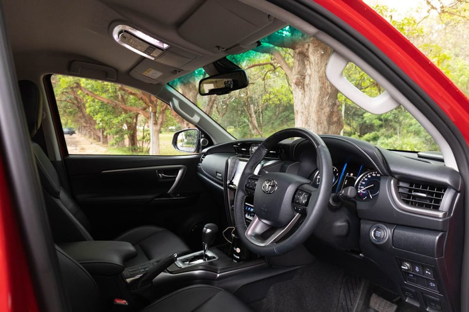 The Fortuner has a leather-accented interior and a woodgrain look steering wheel.