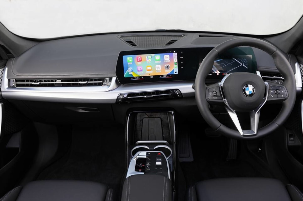 The X1’s dash is dominated by a large, bendy rectangular binnacle BMW calls its Curved Display, that houses two screens. (2023 BMW X1 sDrive18i variant pictured)