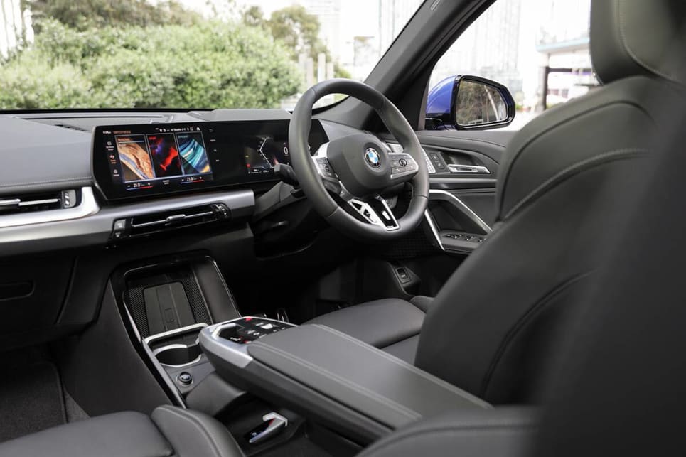 Entry and egress are aided by large doors that open up wide, before sinking into body-hugging front seats that provide great location for an excellent driving position. (2023 BMW X1 sDrive20i variant pictured)