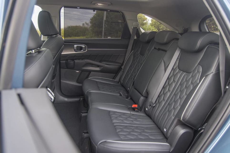Second-row passengers get plenty of room, plenty of amenities, and the outer seats are heated. (image: Glen Sullivan)