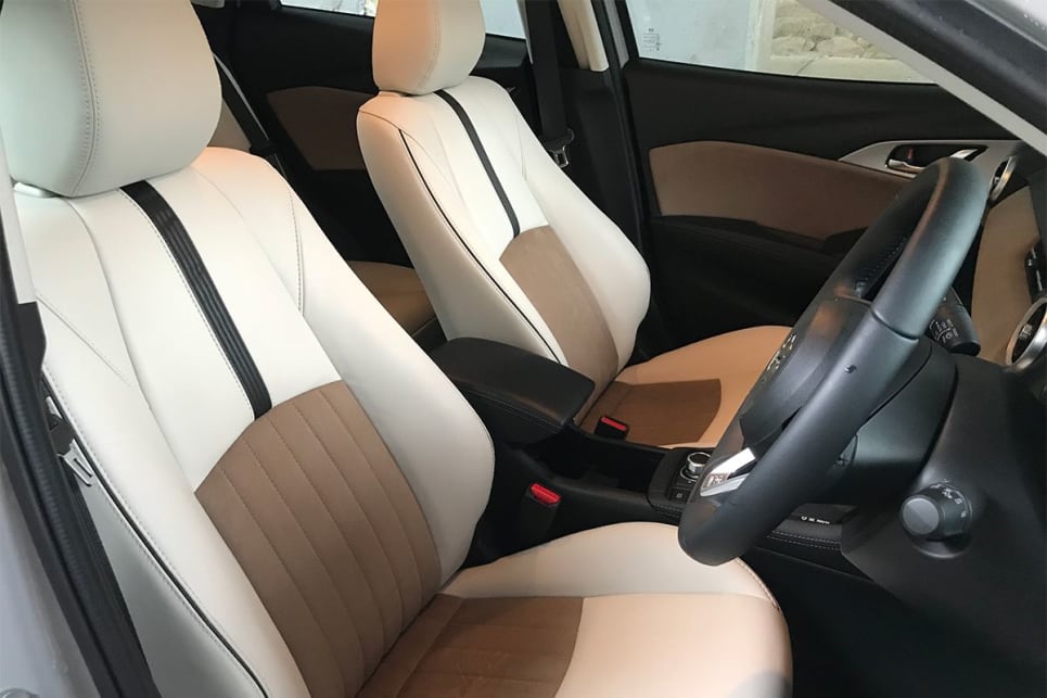 It's still covered with a padded lid which doubles as an armrest, and there’s also a generous glove box and bins in the doors with space for large bottles, even an overhead drop-down glasses holder.
