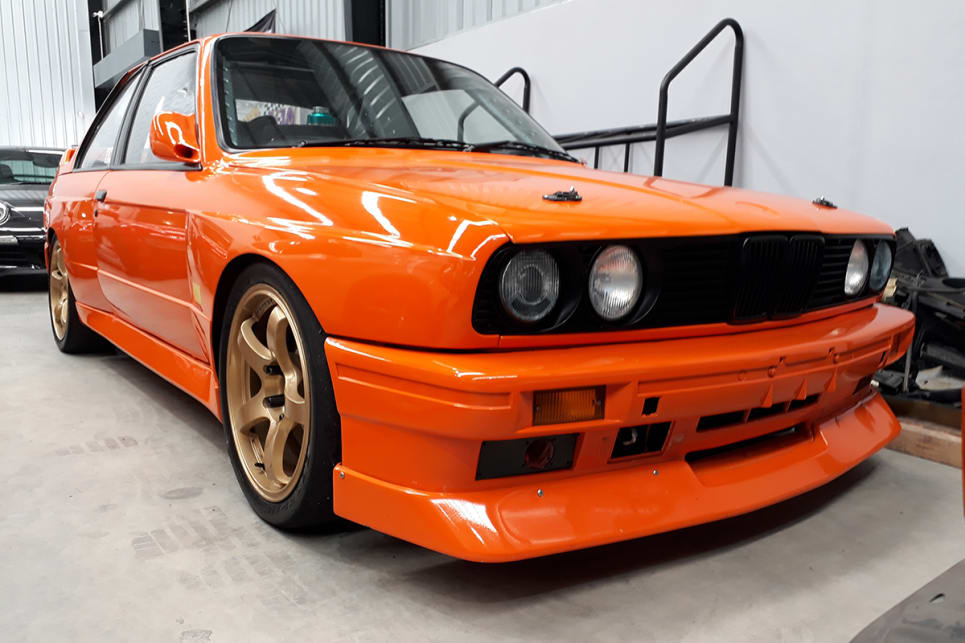 This bright orange E30 BMW M3 is purpose-built for racing.