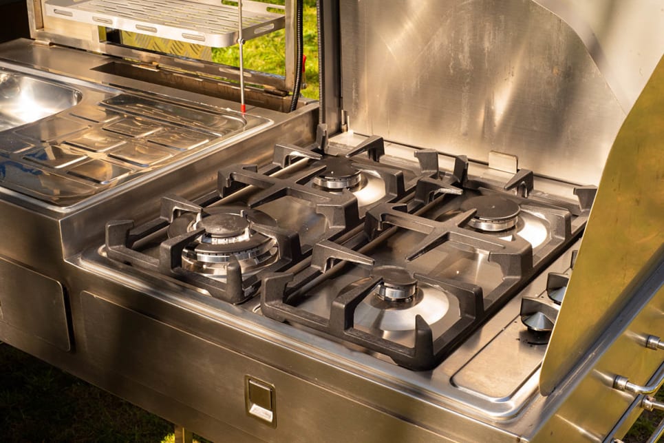 The stainless steel kitchen slides out from the back of the camper.