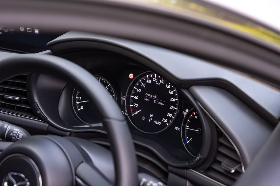 Behind the steering wheel is a semi-digital dash.