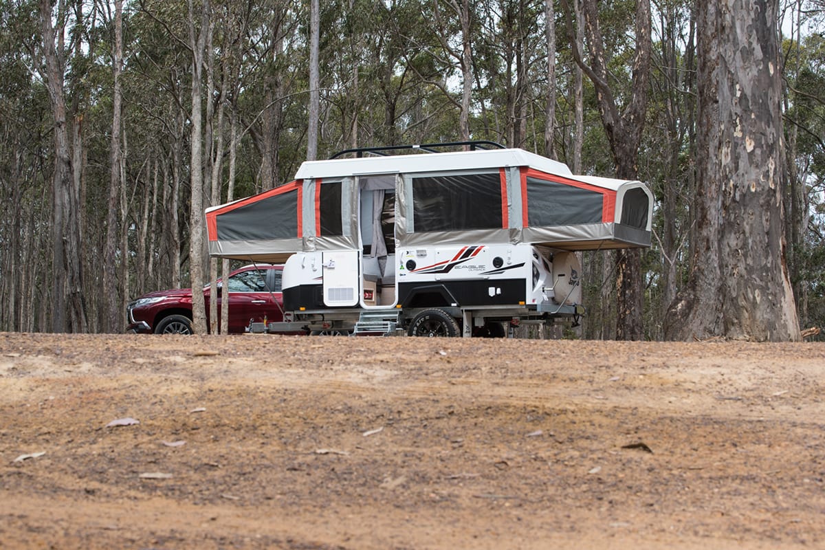 Camper with outlet pop out beds